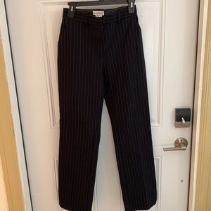 BEBE. Black pinstripe pants with pockets. 1 in back.Size 4. Split on bottom hem